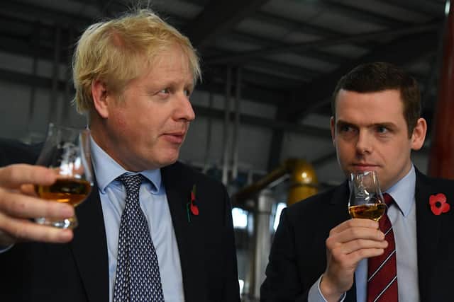 Boris Johnson and Douglas Ross, former leader of the Scottish Conservatives (Picture: Daniel Leal-Olivas/WPA pool/Getty Images)