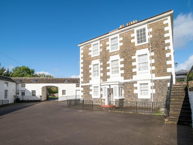 Side of property with courtyard entrance to lower ground floor.