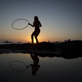 A woman dances during sunset (Picture: AFP/Jaime Reina)
