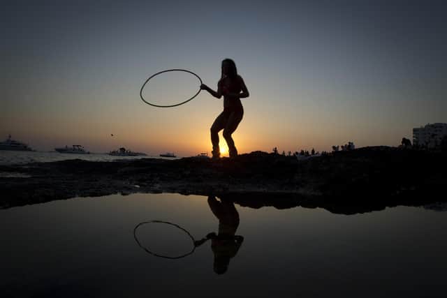 A woman dances during sunset (Picture: AFP/Jaime Reina)