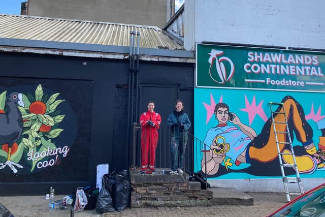 Nikki McGuigan, 30, and Molly Hankinson, 25, standing beside their colourful artwork on Frankfort Street in Shawlands (Photo: Hannah Brown).