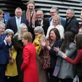 First Minister Nicola Sturgeon hugs SNP candidate Amy Callaghan as she joins SNP's newly elected MPs for a group photo call outside the V&A Museum in Dundee in 2019.