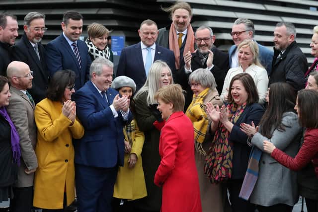 First Minister Nicola Sturgeon hugs SNP candidate Amy Callaghan as she joins SNP's newly elected MPs for a group photo call outside the V&A Museum in Dundee in 2019.