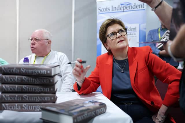 Nicola Sturgeon signs copies of her memoir, Frankly, at the SNP conference in Aberdeen last October (Picture: Jeff J Mitchell/Getty Images)