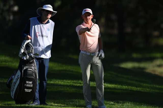 Grant Forrest talks through a shot with caddie John McClure during the Open de Espana at Club de Campo Villa de Madrid. Picture: Stuart Franklin/Getty Images.