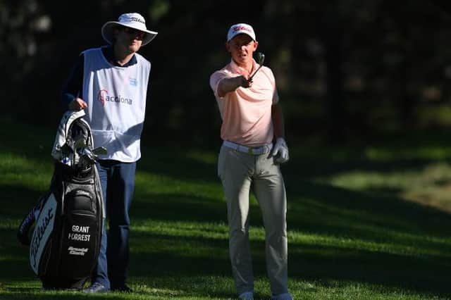 Grant Forrest talks through a shot with caddie John McClure during the Open de Espana at Club de Campo Villa de Madrid. Picture: Stuart Franklin/Getty Images.