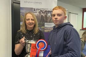Finlay Hunter receiving the Calladrum Cup from sponsor Hazel Moir