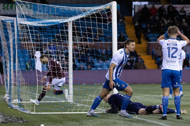 Kilmarnock's David Watson (no. 12), Lewis Mayo and Will Dennis (on ground) look dejected the goal.