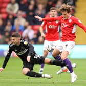 Callum Styles of Barnsley is challenged by Oliver Norwood of Sheffield United.