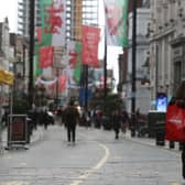 A pedestrian wearing a face mask carries shopping in Cardiff, south Wales, ahead of a short, two-week lockdown. Picture: Geoff Caddick/AFP via Getty Images