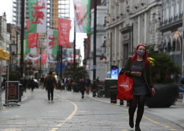 A pedestrian wearing a face mask carries shopping in Cardiff, south Wales, ahead of a short, two-week lockdown. Picture: Geoff Caddick/AFP via Getty Images