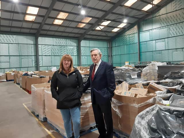 Pauline Buchan and Gordon Brown at the Cottage Centre warehouse filled with goods destined for families in need across Fife