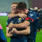 Declan Gallagher (right) drapes himself round Scott McTominay as the pair get lost in the elation of Scotland's penalty-shoot progress to a first major finals in 23 years (Photo by Nikola Krstic / SNS Group)