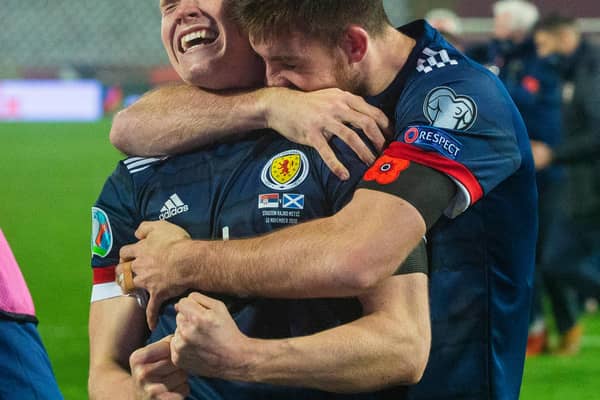 Declan Gallagher (right) drapes himself round Scott McTominay as the pair get lost in the elation of Scotland's penalty-shoot progress to a first major finals in 23 years (Photo by Nikola Krstic / SNS Group)