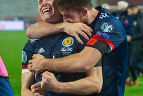 Declan Gallagher (right) drapes himself round Scott McTominay as the pair get lost in the elation of Scotland's penalty-shoot progress to a first major finals in 23 years (Photo by Nikola Krstic / SNS Group)