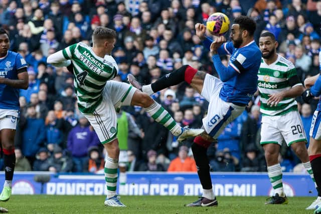 Celtic's Carl Starfelt plays the ball forward and it is blocked by Rangers' Connor Goldson which led to a VAR check for handball.