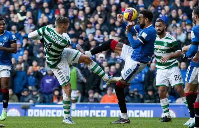 Celtic's Carl Starfelt plays the ball forward and it is blocked by Rangers' Connor Goldson which led to a VAR check for handball.