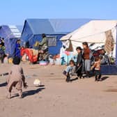 Afghan children play near their makeshift tents at Nayeb Rafi village in Zendeh Jan district of Herat province on 10 December, two months since the first of three earthquakes to hit the region.