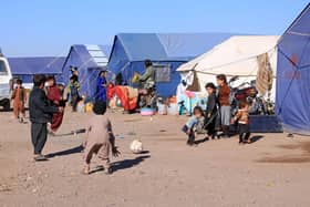 Afghan children play near their makeshift tents at Nayeb Rafi village in Zendeh Jan district of Herat province on 10 December, two months since the first of three earthquakes to hit the region.