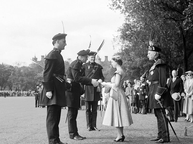The Queen is pictured presenting prizes to Major AC Blair during the visit to the Meadows.