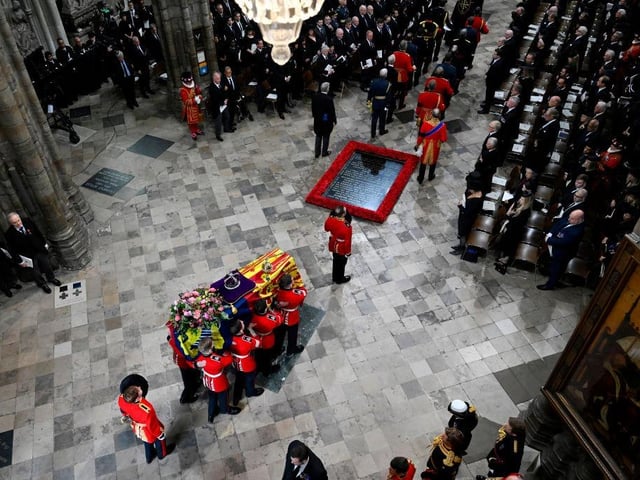 LONDON, ENGLAND - SEPTEMBER 19: The coffin of Queen Elizabeth II with the Imperial State Crown resting on top is carried by the Bearer Party into Westminster Abbey during the State Funeral of Queen Elizabeth II on September 19, 2022 in London, England. Elizabeth Alexandra Mary Windsor was born in Bruton Street, Mayfair, London on 21 April 1926. She married Prince Philip in 1947 and ascended the throne of the United Kingdom and Commonwealth on 6 February 1952 after the death of her Father, King George VI. Queen Elizabeth II died at Balmoral Castle in Scotland on September 8, 2022, and is succeeded by her eldest son, King Charles III.  (Photo by Gareth Cattermole/Getty Images)