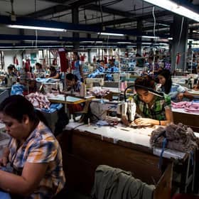 Labours work at a garment factory in Yangon in 2018.
