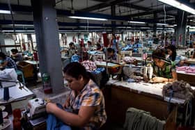 Labours work at a garment factory in Yangon in 2018.