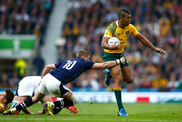 Finn Russell tries to stop Kurtley Beale during the 2015 Rugby World Cup quarter-final between Australia and Scotland at Twickenham.  (Photo by Shaun Botterill/Getty Images)