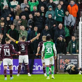 Lawrence Shankland celebrates in front of the Hibs fans after netting a penalty for Hearts.