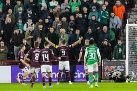 Lawrence Shankland celebrates in front of the Hibs fans after netting a penalty for Hearts.