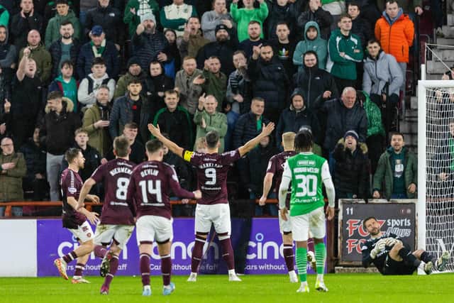 Lawrence Shankland celebrates in front of the Hibs fans after netting a penalty for Hearts.