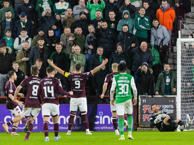 Lawrence Shankland celebrates in front of the Hibs fans after netting a penalty for Hearts.