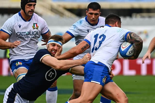 Scotland lock Nick Haining tackles Italy centre Marco Zanon.