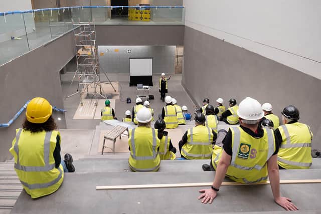 A briefing for workers at the newly-created central staircase at the Burrell Collection.