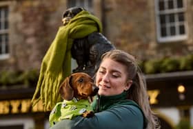 Edinburgh Dog and Cat Home staff member Jennifer Mallen with her 4 year old Daschund Cupar adorning the Greyfriars Bobby and Bum the Dog statues in Edinburgh with scarves to symbolise warmth and compassion that the community can provide to vulnerable animals and their owners during these cold months.