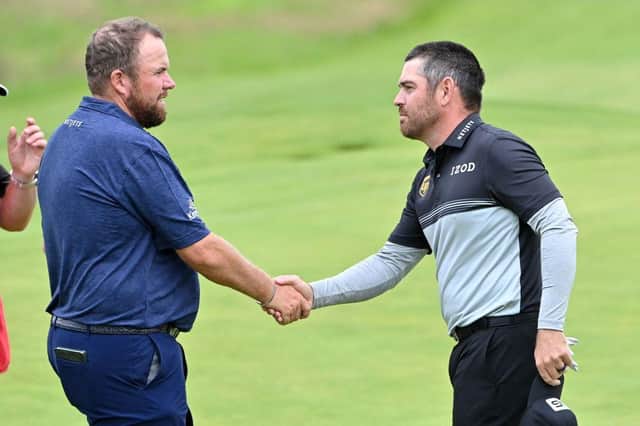 Defending champion Shane Lowry shakes hands with Louis Oosthuizen after their opening round in the 149th Open at Royal St George's. Picture: Paul Ellis/AFP via Getty Images.