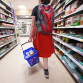 A shopper walking through the aisle of a Tesco supermarket. The UK Government wants to encourage supermarket to place a price cap on basic food items such as bread. Picture: Yui Mok/PA Wire