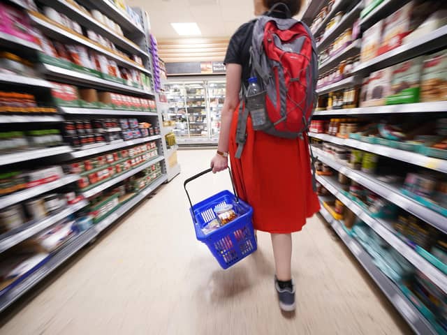 A shopper walking through the aisle of a Tesco supermarket. The UK Government wants to encourage supermarket to place a price cap on basic food items such as bread. Picture: Yui Mok/PA Wire