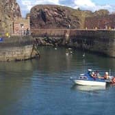 The lifeboat tows the stricken vessel into Dunbar harbour. Picture: Ian Wilson/Dunbar RNLI
