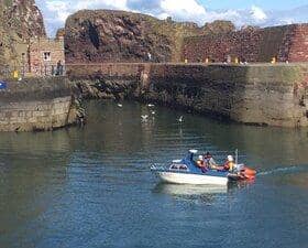 The lifeboat tows the stricken vessel into Dunbar harbour. Picture: Ian Wilson/Dunbar RNLI