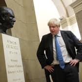 Boris Johnson looks at a bust of Winston Churchill in 2021; both have come under fire over comments made while they were prime minister (Picture: Kevin Dietsch/Getty Images)