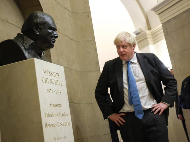 Boris Johnson looks at a bust of Winston Churchill in 2021; both have come under fire over comments made while they were prime minister (Picture: Kevin Dietsch/Getty Images)