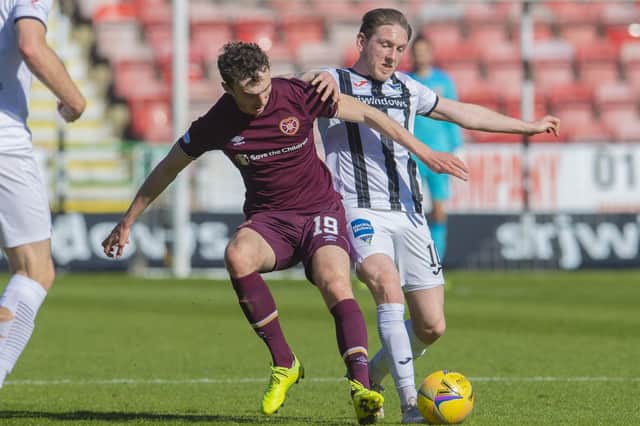 Hearts' Andy Irving and Dunfermline's Declan McManus jostle for possession.