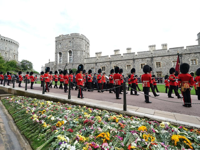 The State Hearse carrying the coffin of Queen Elizabeth II, draped in the Royal Standard with the Imperial State Crown and the Sovereign's Orb and Sceptre, at the Committal Service for Queen Elizabeth II held at St George's Chapel in Windsor Castle, Berkshire. Picture date: Monday September 19, 2022.