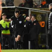 Celtic manager Ange Postecoglou watches on as referee Don Robertson rules out a penalty award.