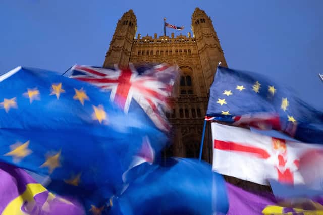 EU and Union flags flutter in the breeze as Pro and anti-Brexit demonstrators protest outside of the Houses of Parliament in central London in 2019. Picture: Tolga Akmen/AFP via Getty Images