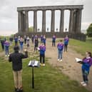 The National Youth Choir of Scotland, with founder and conductor Christopher Bell, meet on Calton Hill, Edinburgh, to sing together in person for the first time since March last year (Picture: Jane Barlow/PA Wire)