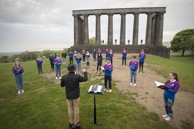 The National Youth Choir of Scotland, with founder and conductor Christopher Bell, meet on Calton Hill, Edinburgh, to sing together in person for the first time since March last year (Picture: Jane Barlow/PA Wire)