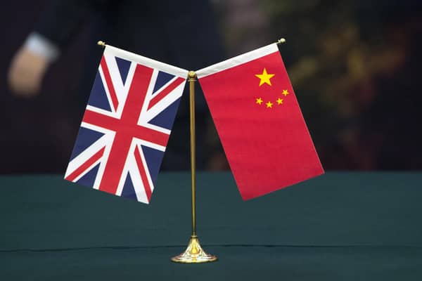 The union flag and the flag of the People's republic of China. The researcher arrested over spying allegations has claimed he is innocent. Picture: Arthur Edwards/The Sun/PA Wire