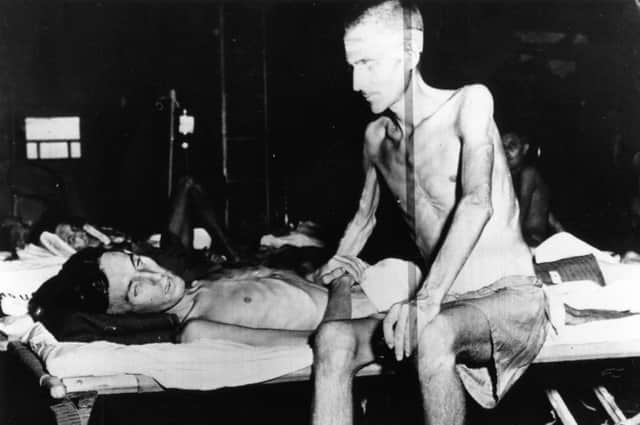 Two emaciated soldiers on a US ship after being liberated from a Japanese prisoner of war camp in 1945 (Picture: Keystone/Getty Images)